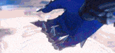 a close up of a person 's hand with sharp claws .