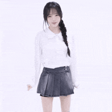 a girl wearing a white shirt and a black pleated skirt