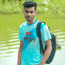 a young man wearing a blue shirt that says envy