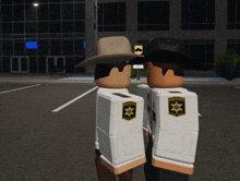 two sheriff 's officers standing next to each other in front of a building