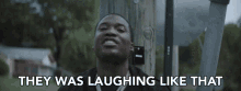 a man is laughing with the words " they was laughing like that " behind him