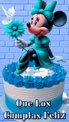 a picture of minnie mouse on a birthday cake with que los cumplas feliz written below it