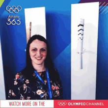 a woman stands in front of an olympic torch with the words watch more on the olympic channel