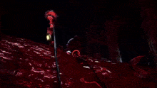 a cartoon character is holding a purple object in his hand in the dark .
