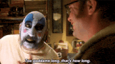 a man in a clown mask is talking to another man who is wearing glasses