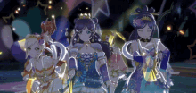 a group of anime girls are dancing together on a stage