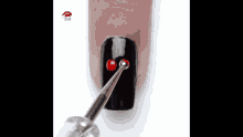 a woman 's nails are painted black and red with a cherry on them