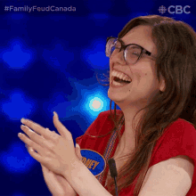 a woman wearing glasses and a red shirt with the name sidney on it