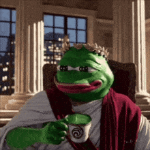 a green frog with a crown on his head is drinking a cup of coffee