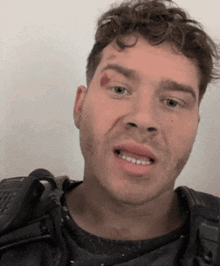 a close up of a man 's face with a bloody eye