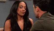 a man and a woman are looking at each other