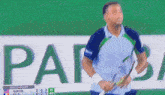 a man stands in front of a scoreboard that says " match point "
