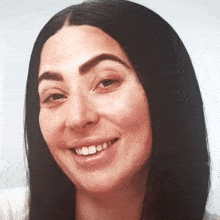 a close up of a woman 's face with a smile
