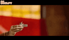 a person is holding a lighter in their hand in a blurry photo .