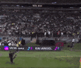 a soccer stadium with a sign that says kai angel