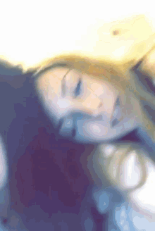 a blurry picture of a woman 's face with her eyes closed