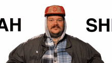 a man wearing a hat and a jacket says ah shit