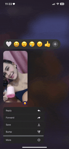 a phone screen shows a woman holding a pink container and a reply button