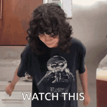 a person wearing a t-shirt that says " watch this "