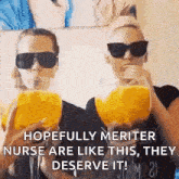 two women wearing sunglasses are drinking orange juice from glasses .