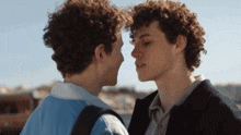 two men with curly hair are looking at each other with the word okay on the bottom