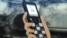 a person is holding a cell phone with chinese characters on it
