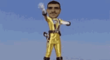 a young man in a yellow superhero costume is giving a thumbs up .
