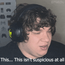 a man wearing headphones with the caption this isn 't suspicious at all