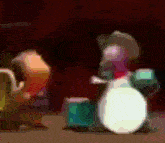a blurry picture of a person playing drums in a dark room .