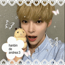 a picture of a boy with a hamster and the name hanbin de andrea