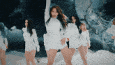 a group of women are dancing in the snow