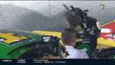 a kevin harvick race car is being filmed by a cameraman