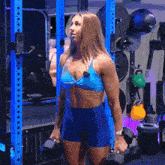 a woman in a blue top has a tattoo on her stomach that says ' i 'm a girl ' on it