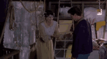 a man and woman are standing next to each other in a room