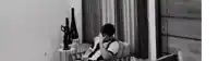 a man is sitting on a couch talking on a cell phone in a living room .