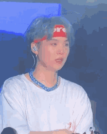 a young man wearing a headband with the word supreme on it