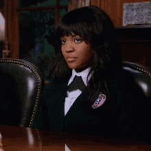 a girl in a school uniform has a badge on her jacket that says ' oei '