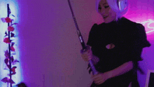 a woman is holding a sword in front of a neon sign that says ' s '