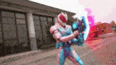 a person in a pink and blue costume holding a gun