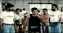 a group of people standing in a room with the word siri on the bottom right
