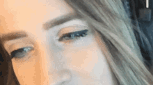 a close up of a woman 's face with her eyes closed and her eyebrows visible .