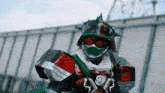 a robot with a helmet and goggles is standing in front of a wall