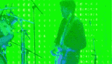 a man and a woman are playing instruments on a green screen .