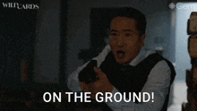 a man holding a gun with the words on the ground below him