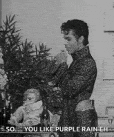 a black and white photo of prince holding a glass of wine .