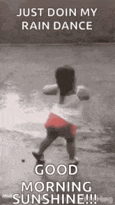 a little girl is dancing in the rain and says `` just doin my rain dance good morning sunshine '' .