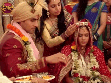 a bride and groom are getting ready for their wedding with a dangal tv logo behind them