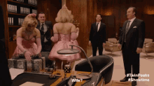 a woman in a pink dress is standing next to a man in a suit with the words wife written on the bottom