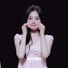 a woman in a pink dress making a funny face