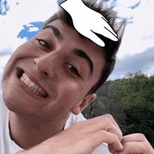 a man is smiling with a hand on his head